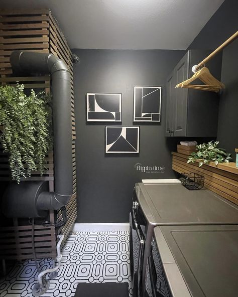 Incredible transformation in just two days! The decision to paint the walls ‘Iron Ore’ from @sherwinwilliams was spot on—it adds a dramatic and modern vibe. The sleek wood slat panel is a perfect way to hide the washer and dryer hookups, and it complements the bold geometric flooring perfectly. This laundry room makeover is seriously one of my favorites. #LaundryRoomMakeover #HomeTransformation #IronOre #SherwinWilliams #ModernDesign #DIYHome #InteriorInspo #LaundryRoomGoals #furnitureartis... Laundry Room Workout Room Combo, Black Laundry Room Ideas, Black White Laundry Room, Black Laundry Room, Laundry Room Pantry, Grey Laundry Rooms, Hgtv Design, White Laundry Rooms, Hgtv Designers