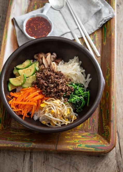 Various vegetables and ground beef bulgogi are arranged over rice in a stone bowl to make bibimbap Ground Beef Bibimbap, Easy Bibimbap, Ground Beef Bulgogi, Beef Bibimbap, Bulgogi Bibimbap, Dorm Meals, Bibimbap Sauce, Korean Rice Bowl, Menu Photography