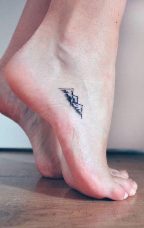 mountains-minimalist-tattoo Tiny Foot Tattoos, Small Mountain Tattoo, Delicate Tattoo, Most Popular Tattoos, Symbol Tattoos, Mountain Tattoo, An Arrow, Small Tattoo Designs, Foot Tattoo