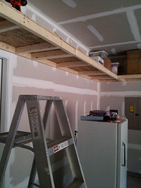 Garage Stairwell Ideas, Mezzanine Garage, Garage Shelving Plans, Diy Overhead Garage Storage, Garage Hanging Storage, Hanging Garage Shelves, Garage Storage Plans, Garage Wall Shelving, Garage Organizing