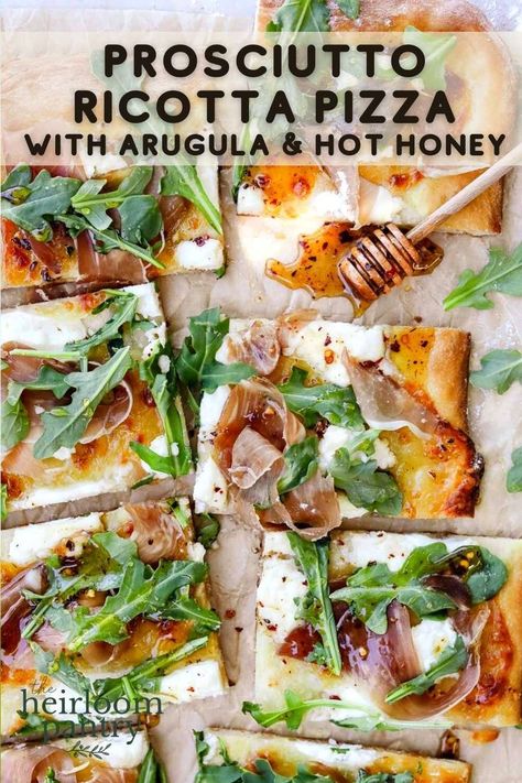 Prosciutto ricotta pizza with arugula and hot honey cut into slices on parchment paper. Pesto Prosciutto Pizza, Pizza Arugula Prosciutto, Arugula Balsamic Pizza, Arugula Proscuitto Pizza, Lemon Ricotta Flatbread, Peach Ricotta Pizza, Procuitto Arugula Pizza, Date Night In Food Ideas, Riccota Pizza Recipe