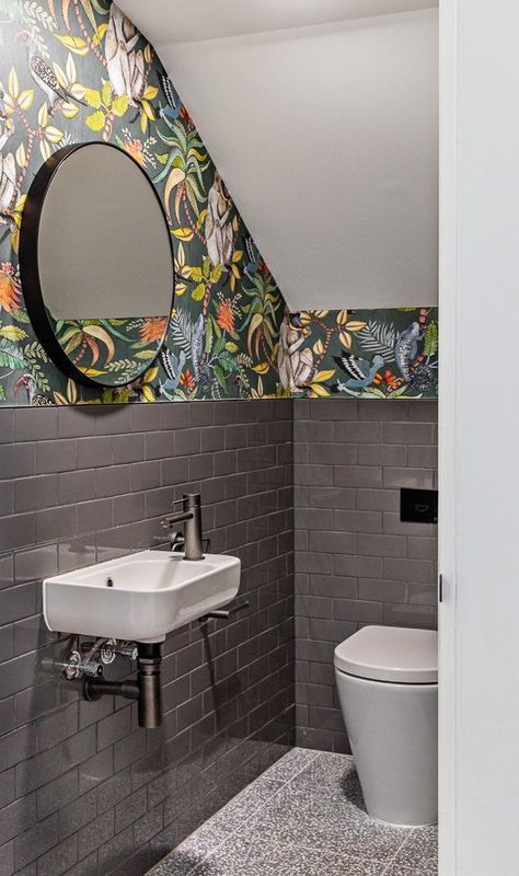 An under-the-stairs powder room is transformed into an exciting space in this home in Australia, where the gray subway tile gives way to a colorful printed wallpaper. #dwell #modernbathroomideas #bathroomdesignideas #powderrooms Modern Powder Room Design, Understairs Toilet, Powder Room Design Ideas, Room Under Stairs, تحت الدرج, Small Downstairs Toilet, Bathroom Under Stairs, Toilet Room Decor, Small Toilet Room