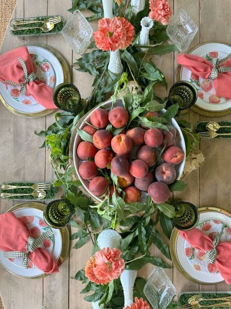 We're in the peak of peach season so it's the perfect time to create a unique tablescape with these beauties. I'm sharing some peach inspired tablescape ideas for summer entertaining with you. Fresh peaches, peach leaves, fresh flowers in orange and peach hues, thrifted plates, and vintage goblets were some of the things I used to create a unique summer table. I also shared a creative way to display your flatware and some tips for finding beautiful items for table decor on a budget. Peach Table Setting, Thrifted Plates, Peach Leaves, Potluck Dinner Party, Wedding Table Display, Yard Sale Signs, Grilled Peach Salad, Summer Tablescapes, Peach Salsa