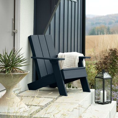 Create a new focal point in your outdoor space with this Adirondack chair. Three oversized back slats put a contemporary spin on what is truly an American classic, the Adirondack chair. Wide arms and legs combine maximum comfort with modern beauty. Pair with the Byrnes modern side table for a fresh take on a traditional backyard favourite or explore the entire line of products to coordinate other beautiful, durable products that will make your outdoor living space the envy of the neighbourhood. Modern Front Porch Chairs, City Balcony, Backyard Dining, Modern Adirondack Chair, Modern Outdoor Chairs, Cottage Porch, Modern Adirondack, Porch Chairs, Plastic Adirondack Chairs