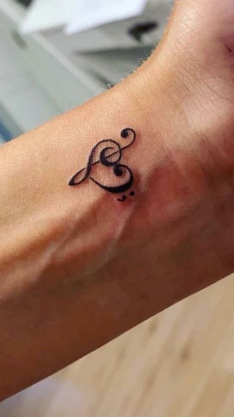 Harmony in Ink: Music notes tattoo ideas. Explore designs that capture the rhythm and melody of your favorite tunes in a timeless and artistic symphony. Music Note Tattoo Ideas, Music Symbol Tattoo, Small Music Tattoos, Notes Tattoo, Small Dope Tattoos, Black People Tattoos, Music Notes Tattoo, Small Girly Tattoos, Grunge Tattoo