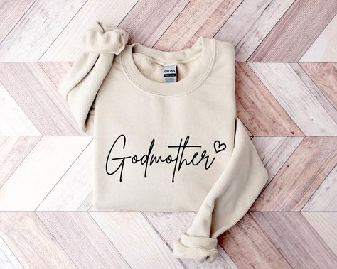 Godmother Sweatshirt, Best Godmother Hoodie from Godchild, Perfect Godmother Present, Birthday, Winter Crewneck Gift Idea, Love Nana Shirt *HOW TO ORDER* 1. Select the shirt 𝗦𝘁𝘆𝗹𝗲 2. Select the 𝗦𝗶𝘇𝗲 3. Select the shirt color 4. Select the quantity, 5. Click 𝗔𝗗𝗗 𝗧𝗢 𝗖𝗔𝗥𝗧. If you want to buy more than one, please go back to the listing and repeat the steps. "If you have any question, please send us a message." *BRAND* If you want a specific brand, please send us a message right after you place the order. Otherwise, we will send you the t-shirt according to what we have in stock. *SIZE CHART* We suggest you choose the size you usually wear. They are true to size. *CARE INSTRUCTIONS* Turn the sweatshirt inside out before washing. Wash with similar items. Use a mild detergent.