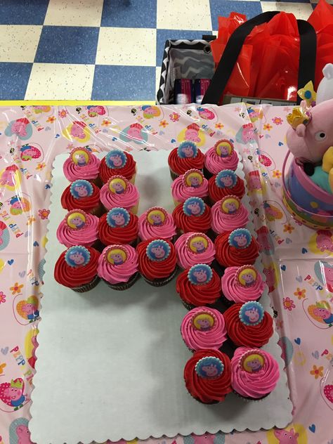 Peppa Pig number 4 cupcake cake with Peppa Pig rings on top. Number 4 Peppa Pig Cake, Number 4 Cake With Cupcakes, Number 4 Cupcakes, 4 Cupcake Cake Number, Number 4 Cupcake Cake, 4 Cupcake Cake, School Cupcakes, Curious George Birthday Party, Number Birthday Cakes