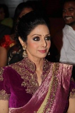 Sridevi in Purple regal saree blouse with high neck style and gold embroidery around the neck and sleeves High Neck Saree Blouse, Velvet Blouse Design, Magenta Velvet, Velvet Saree, Saree Jackets, Saree Blouse Styles, Blouse Designs High Neck, Fashionable Saree Blouse Designs, Velvet Blouse