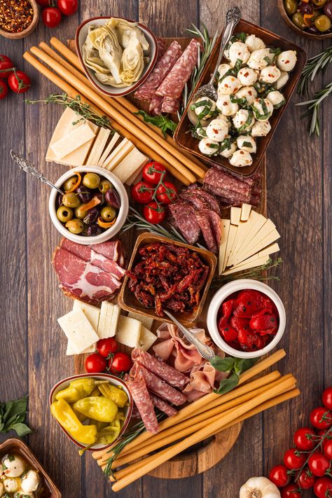 This Antipasto Platter is filled with gorgeous Italian meats, cheeses, vegetables and more. We have also included two easy recipes to make your appetizer rise above the rest. Italian Crudite Platter Ideas, Italian Antipasto Charcuterie Board, Italian Charturie Board, Italian Charcuterie Board Antipasto Platter, Meat And Cheese Board Simple, Italian New Years Eve Dinner, Antipasta Platters Italian, Italian Buffet Ideas Dinners, Christmas Meat And Cheese Board