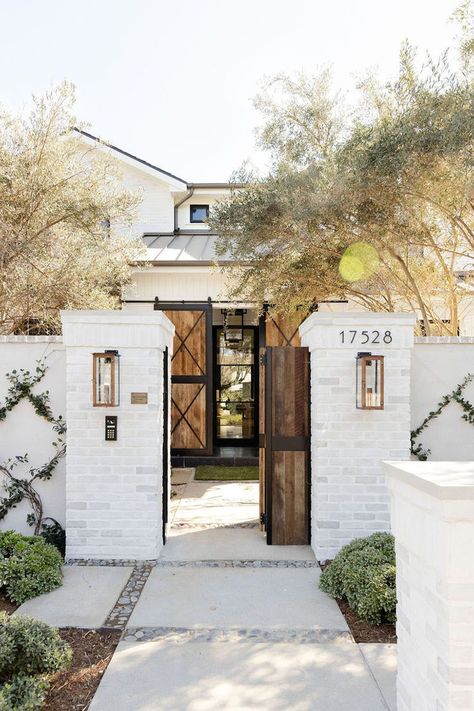 This gorgeous modern farmhouse-style home was designed by Red Door Homes, located in Los Angeles, California. Spanish Ranch, Blue Stone Floors, Modern Farmhouse Exterior Colors, California Farmhouse, House Mediterranean, Entry Doors With Glass, San Juan Capistrano, Modern Farmhouse Exterior, Mountain Homes