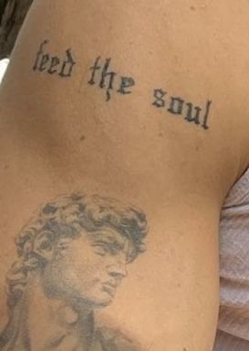 Tattoo that says ‘feed the soul’ in gothic letters Feed Your Soul Tattoo, Feed The Soul Tattoo, Lover Boy Tattoo, Celebrity Tattoos Male, Geisha Tattoo Design, Feed The Soul, Matching Tats, Aesthetic Writing, Soul Tattoo