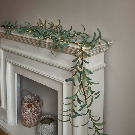 String Lights Aren't Just for Christmas: 13 Ideas to Decorate With Them Year-Round - Bob Vila Olive Garland, Holiday Fireplace Decor, Outdoor Room Decor, Wedding Fireplace, Garland Lights, Holiday Fireplace, Pre Lit Garland, Patio Wedding, Fireplace Mantle Decor