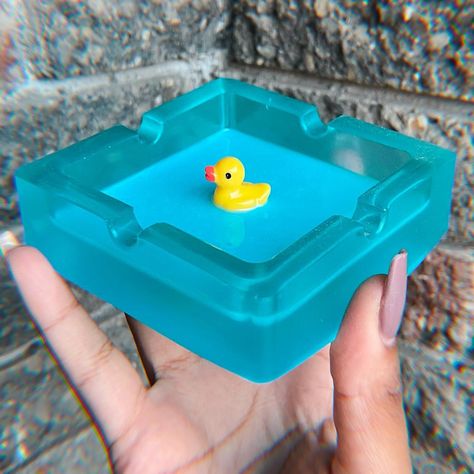 bath duck ashtray 🐥🫧   Discover the perfect blend of functionality and art with our handcrafted resin ashtrays. Each piece is meticulously made, offering a unique design that adds a touch of elegance to any space. Ideal for both smokers and decor enthusiasts. #Handcrafted #ResinArt #UniqueDesign #StylishHome #AshtrayArt #HomeDecor #HandmadeCrafts #ArtisanMade #FunctionalArt #DecorInspiration#duck #bathduck #whattheduck #ducklife Resin Ashtray Ideas, Epoxy Ashtray, Bath Duck, Hot Glue Art, Resin Ashtray, What The Duck, Glue Art, Resin Artwork, Ashtrays