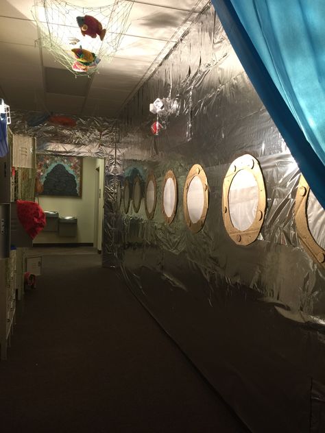 Hall to the bathroom decorated like the peep holes of a submarine. Walls made of aluminum foil, cardboard, and wax paper. Inside Of A Submarine, Submarine Photo Booth, Scuba Vbs Submarine, Submarine Decorations Under The Sea, Inside Submarine Decorations, Inside A Submarine, Scuba Vbs Imagination Station, Scuba Vbs Stage Decorations, Cruise Theme Decorations