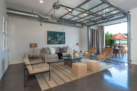 garage living room Cozy Garage Ideas Spaces, Garage Door Window Cover, Living Room With Garage Door, Garage Conversion Living Room, Garage Into Sunroom, Garage As Entertaining Space, Glass Garage Door Living Room, Garage Multipurpose Spaces, Garage To Den Conversion