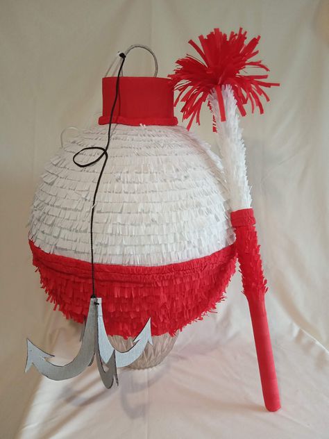 Do you have a fishing addict around? :) You will definitely need this Fishing Bobber pinata then - it will brighten your Fishing themed party! Isn't it nice? :) The Bobber pinata is a lovely addition and a great fun for a birthday kid as well as for the guests. This listing is for a Large sized pinata. Diameter - near 18 in (45cm). Round shape. The pinata can hold up to 7 pounds of candies and party favors (not included).  Lots of room to put plenty of goodies! Easy to load through a special pre Camping Fishing Birthday Party, Bobber Pinata, Fishing Derby Birthday Party, Fishing Pinata, Fishing Party Activities, How To Make A Fish Pinata, Fishing Party Theme, Pirate Party Pinata, Party Fishing Game