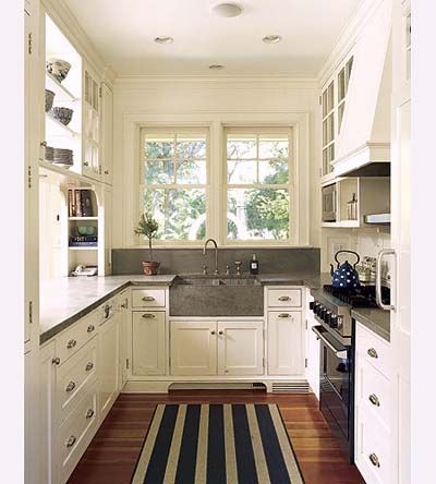 another galley kitchen i love for the condo....soapstone (?) sink, backsplash & counters. , cupboards, built-ins, shelves in front of windows. Small Galley Kitchen Remodel, Küchen In U Form, Small White Kitchens, Small Galley Kitchen, Galley Kitchen Design, Best Kitchen Design, Galley Kitchen Remodel, Galley Style Kitchen, Galley Kitchens