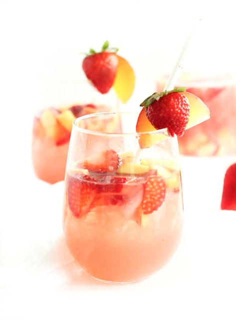 This fruity rosé sangria made with strawberries, peaches and raspberry puree is an easy and delicious summer party drink to serve at backyard BBQs and to sip by the pool! | via livelytable.com Processco Cocktails, Summer Punch Recipes, Summer Party Drink, Vodka Mixed Drinks, Holiday Punch Recipe, Basil Lemonade, Rose Sangria, Yummy Cocktails, Summer Cocktail Recipes