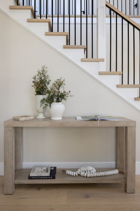 A perfect example of transitional style—featuring a staircase and console table, beautifully designed by Serendipite Designs—this is an elegant eye-catching look for any home! Interiors @serendipitedesigns Photo @mollyrose.photo #homedesign #transitionalstyle #remodelgoals #diningroomdesign #interiordesigninspiration #interiordesignlovers #interiordesigninspo #designer #style #luxuryliving #interiordesigner #remodel #stairs #home #diningroom #furnituredesign #interiordesign #interiorinspo Staircase Console Table, Console Table In Front Of Stairs, Table At Bottom Of Stairs, Console Table Stairs, Console Table By Stairs, Entrance Tables, Stairs Home, Remodel Stairs, Camden Park