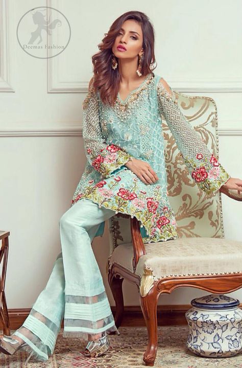 This outstanding self embroidered short frock embellished with floral thread embroidery. It is allured with resham, kora, dabka, tilla and pearls. Sleeves are decorated with cold shoulders design and floral embroidery. Scalloped hemline ornamented with tassels. It is beautifully paired up with matching bell bottom trouser. It comes with light blue dupatta sprinkled with sequins all over it. Frock Suit Design, Bell Bottom Trouser, Pakistani Casual Wear, Frock Suit, Mode Ab 50, Short Frocks, Chiffon Suit, Bell Bottom Trousers, Short Frock