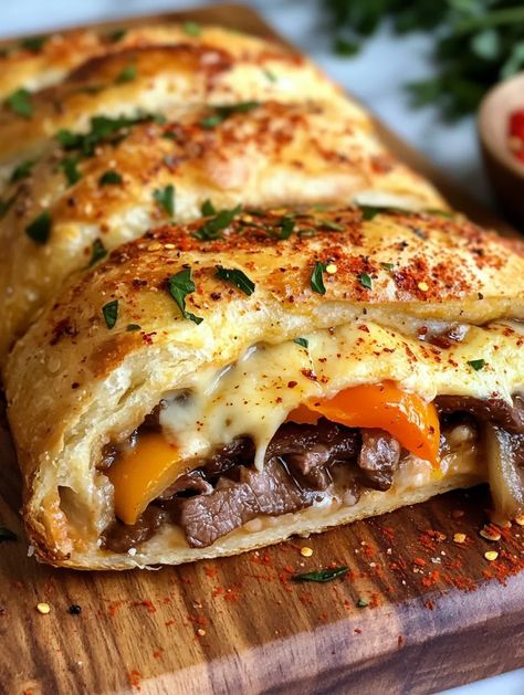 Craving the irresistible flavors of a Philly cheesesteak? Get ready to elevate your culinary skills with this Philly Cheesesteak Stromboli! Imagine a warm, golden pastry filled with tender ribeye steak, sautéed peppers and onions, and a delightful blend of provolone and mozzarella cheese. This dish is not only a crowd-pleaser but also adds a unique twist to your typical cheesesteak, making it ... Philly Cheese Steak Tortilla, Stromboli Philly Cheesesteak, Philly Cheesesteak Stromboli Recipe, Veggie Philly Cheesesteak, Philly Cheese Steak Appetizer, Steak And Cheese Stromboli, Philly Cheesesteak Stromboli, Philly Cheese Steak Stromboli, Philly Cheese Steak Stromboli Recipe