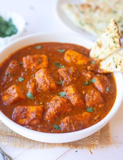 Paneer Vindaloo is the vegetarian version of the restaurant favorite Goan Vindaloo Curry. Paneer cubes are cooked in a fiery-red sauce packed with bold flavors. Enjoy this gluten-free curry with rice or naan for a satisfying dinner! | vegetarian indian recipe | indian curry | paneer recipes | pipingpotcurry.com Paneer Vindaloo, Indian Cucumber Salad, Indian Paneer Recipes, Vindaloo Curry, Sauteed Tofu, Saag Aloo, Vindaloo Recipe, Curry With Rice, Paneer Dishes