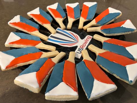 Oar shaped cookies decorated to look like US Rowing oars. Cutter by @bobbiscutters Rowing Themed Party, Rowing Oars, Frosted Tips, Sports Banquet, Shaped Cookies, Theme Party Decorations, Cookies Decorated, Shaped Cookie, Food Themes