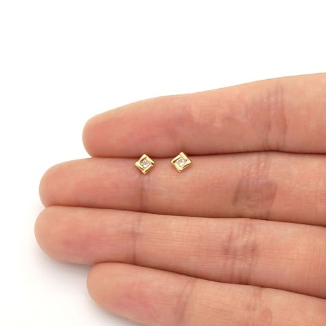 These cute and dainty square earrings are sparkled with dazzling round cut white zircon gemstones. The studs are safely secured with comfortable baby screwback closure. The earrings also come in 14k yellow and white gold variations. Product Specifics   Metal 14k Yellow Gold/ 14k White... Baby Earrings Gold Indian, Baby Earrings Gold, Earrings Gold Indian, Small Diamond Stud Earrings, Kids Gold Jewelry, Gold Earrings For Kids, Small Earrings Gold, Tiny Gold Studs, Baby Earrings