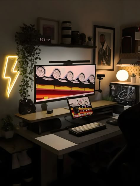 An organized workspace featuring a neon lightning bolt, warm lighting, dual monitors, and cozy decor, creating a modern and inviting atmosphere. Productive Desk Setup, Cozy Desk Ideas, Neon Lightning Bolt, Trading Office, Gaming Computer Room, Cozy Desk Setup, Minimal Desk Setup, Simple Computer Desk, Desk Setup Ideas