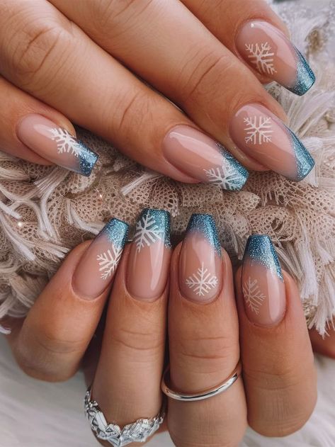 This elegant winter nail art features a glittery blue French tip with delicate white snowflakes. The clear base highlights the festive snowflakes, while the shimmering blue adds a frosty touch, perfect for a holiday or winter-themed look. Blue Christmas Nails, Snowflake Nail Design, Winter Manicure, Winter Nails Acrylic, Cute Christmas Nails, Blue Nail Designs, Snowflake Nails, White Nail Designs, Christmas Nails Acrylic