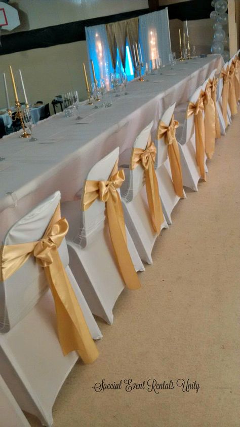 white spandex chair covers gold sashes Gold Chair Covers, White Seat Covers, Simple Church Wedding, Ivory Chair, White Chair Covers, Gold Sash, Gold Tulle, White Spandex, Prom Decor