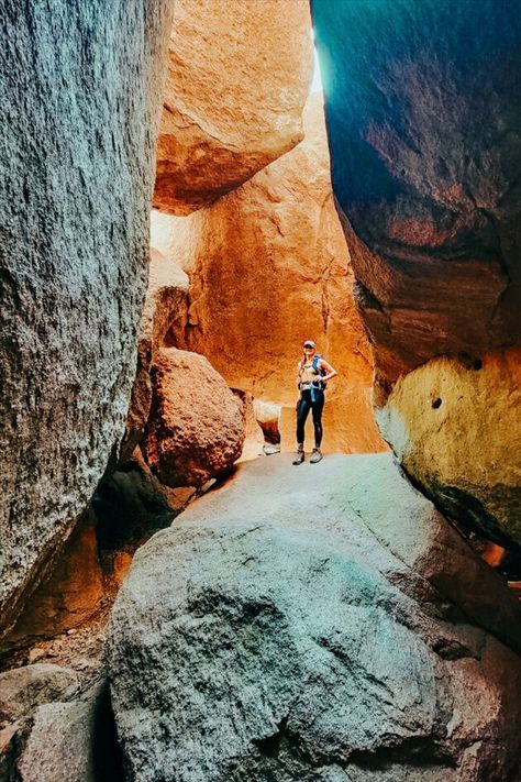 A woman is standing on a giant boulder. The boulder has other massive boulders around it and even resting on it, forming an almost cave-like enclosure. Medicine Park Oklahoma, Wichita Mountains Oklahoma, Oklahoma Attractions, Wichita Mountains, Oklahoma Travel, Mountain Trail, Travel Oklahoma, Mountain Trails, Travel Tourism