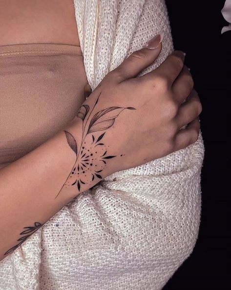 20 Wrist Tattoo Ideas for Women - Mom's Got the Stuff Arm Wrap Tattoos For Women Mandala, Top Of The Wrist Tattoos For Women, Wrist Tattoo Unique, Half Cuff Tattoo, Hand Wrap Tattoos For Women, Flower Wrap Around Wrist Tattoo, How To Connect Tattoos For A Sleeve, Thumb And Wrist Tattoo, Forearm And Wrist Tattoos