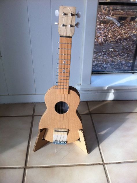 Picture of Display Your Ukulele! Cardboard Guitars, Kids Guitar Craft, Cardboard Guitar, Ukulele Stand, Recycling Diy, Guitar Crafts, Acoustic Guitar Case, Cardboard Diy, Cardboard Recycling