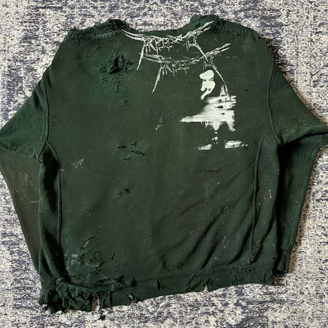 ꧁༺𝓣𝓻𝓲𝓹𝓵𝓮3𝓻𝓭༻꧂ “Victor” Distressed Sweatshirt 1/1 Upcycled Garment —————— “Elegy written in a Country Churchyard” poem pages printed & patched onto this sweater. Poem by Thomas Gray. L’Inconnue De La Seine patch sewn below. Entire piece dyed a murky green. Abstract paint details / patterns throughout. Moderate to heavy distressing + repair. Broken zip @ collar with leather accent. Backside features our new logo print & the talented Yuxia Krendwa (@keisarinnna ) Handmade tag as always🔖 —————— {... Distressing Sweatshirt Diy, Distressed Sweatshirt, Zip Collar, Handmade Tags, Crew Neck Sweatshirt, Dye, Crew Neck, Collar, Sewing