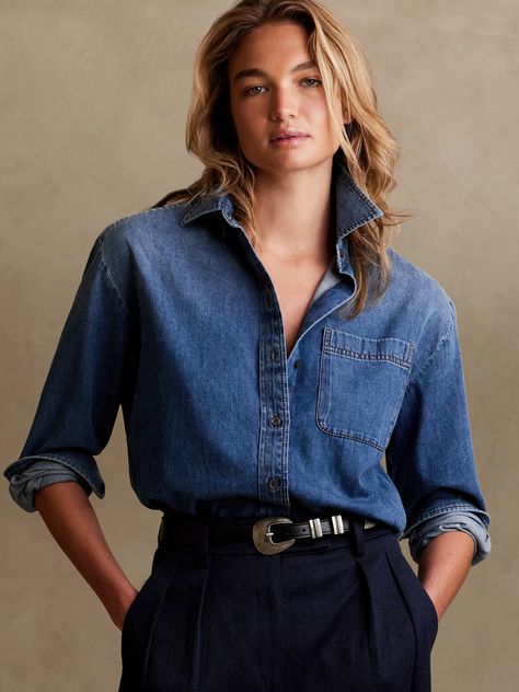 Cut with ease and crafted from lightweight denim, this oversized shirt has high slits at the sides to show off high-waisted styles.  OVERSIZED FIT: Cut for a loose, relaxed fit with a dropped shoulder.  Point collar.  Troca shell button front.  Chest Dark Denim Shirt Outfit, Blue Denim Shirt Outfit, Oversized Denim Shirt Outfit, Denim Shirt Outfits, Denim Shirt Outfit Women, Denim Shirt Women, Plan 2023, Dark Denim Shirt, Denim Shirt Outfit