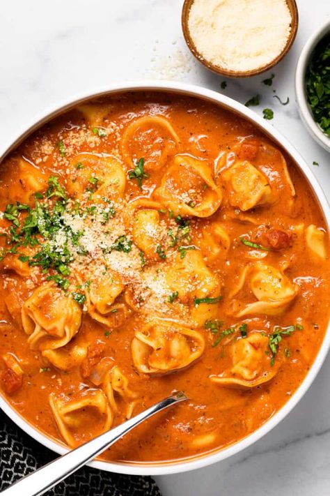 20 minutes is all it takes to get this hearty Tomato Tortellini Soup on the dinner table tonight! The ultimate vegetarian comfort food, this tortellini soup is loaded with crushed tomatoes, cheesy stuffed pasta, and garnished with shaved Parmesan. Tortellini Soup Recipes Easy, Creamy Tomato Tortellini Soup, Creamy Tomato Tortellini, Tomato Tortellini, Creamy Tortellini Soup, Tomato Tortellini Soup, Shaved Parmesan, Stuffed Pasta, Vegetarian Comfort Food