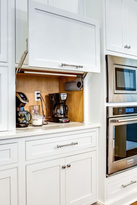 A compact appliance garage nestled on a kitchen countertop, featuring a roll-up door. The interior is equipped with space for storing small kitchen appliances like a toaster, blender, and coffee maker, and electrical outlets so the appliances can stay plugged in for easy use. Built In Kitchen Gadgets, Kitchen Appliance Shelf, Corner Appliance Garage Kitchen, Kitchen Appliances Garage, Garage Appliance Cabinet, Kitchen Small Appliance Storage Ideas, Kitchen Appliances Cabinet, Appliance Cabinet Kitchen, Appliances Kitchen Storage