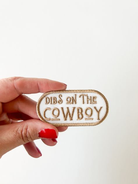 "Product Details: Size: 1 1/4 inched by 2 1/2 inches Material: High-quality embroidered fabric Description: Make your intentions known with our \"Dibs on the Cowboy\" Embroidered Iron-On Patch! This playful and cheeky patch lets everyone know that you've staked your claim on the cowboy of your dreams. Perfect for cowboy enthusiasts and those with a sense of humor, this patch adds a touch of fun to your clothing, bags, or accessories. 🤠💘 Claim Your Cowboy: Declare your affection with this charm Western Airbnb, Western Patches, Dibs On The Cowboy, Cowboy Embroidery, Hat Bar, Cowboy Love, Midnight Cowboy, Cowboy Romance, This Kind Of Love