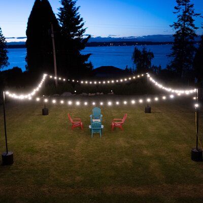 Create instant ambiance by hanging string lights indoors or outdoors using durable IYN String Light Pole Stands. Easily hang string lights for backyards, patios, weddings, restaurants, events, and more. A tank stand can be set up and torn down with no hardware attached to the surface it stands on. The tank stand is filled with water or sand and can be placed anywhere, outside or inside. The durable powder-coated poles are 9’6” tall when assembled and allow you to hang G40 string lights in spans String Lights Indoors, Yard String Lights, Grass Patio, Hanging String Lights, Pole Stand, Tank Stand, Indoor String Lights, Icicle Lights, Light Pole