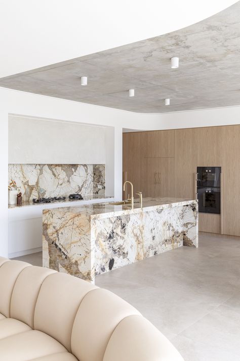 The Mediterranean style kitchen features a quartzite granite Patagonia stone and brushed brass tapware. Contemporary Mediterranean, Kitchen Island Bench, Mediterranean Style Homes, Kitchen Marble, Kitchen Inspiration Design, Kitchen Style, House Inspo, Inspired Homes, 인테리어 디자인