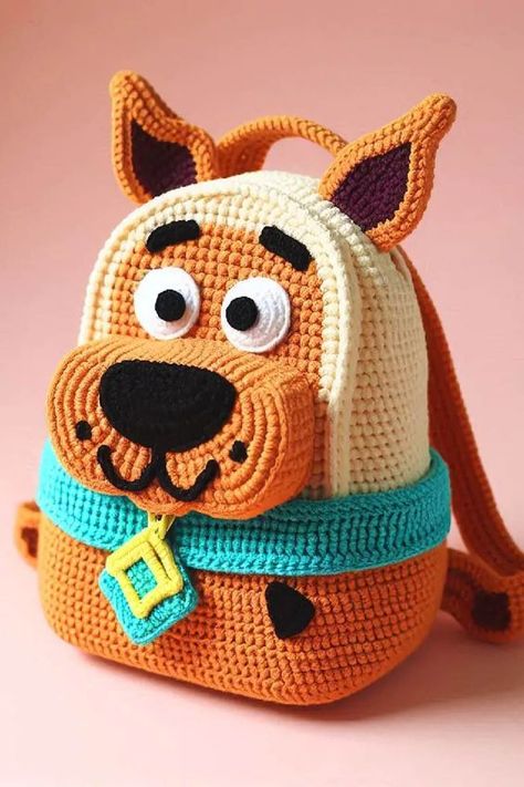 The Scooby-Doo crochet backpack is an adorable and functional accessory that brings to life the beloved character from the iconic cartoon. Scooby Doo Crochet, Iconic Cartoon, Crochet Backpack Pattern, Animal Backpacks, Crochet Disney, Crochet Backpack, Cartoon Bag, Crochet Animals Free Patterns, Backpack Pattern