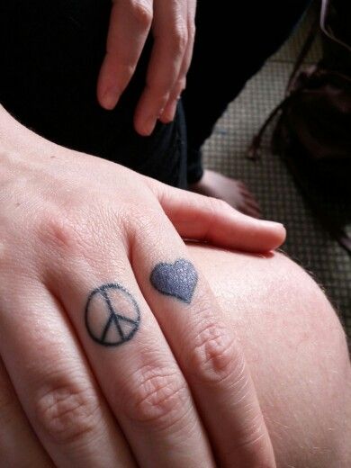 Peace and love finger tattoos Peace And Love Tattoo, Peace Sign Fingers, Love Finger Tattoo, Peace Sign Tattoos, Peace Tattoos, Finger Tattoo, Symbol Tattoos, Skull Tattoos, Dope Tattoos