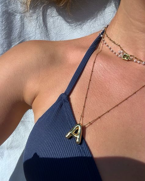 Spotted 👀 Our custom Bubble Initial pendant necklace paired with our sunburst chain & the newest drop — our pearl necklace. Pur custom chains are available in-store and at pop-ups only. DM us to book! 🖤 @sarah.lemire #coastaljewelry #customnecklace #customjewelry #montreal #quebec #pearlnecklace #goldgirlie #jewelrystack #jewelryinspo #waterproofjewelry Necklace With Initials, Elegant Summer Outfits, Coastal Jewelry, Bubble Necklace, Bubble Necklaces, Wrist Jewelry, Pop Ups, Montreal Quebec, Initial Pendant Necklace