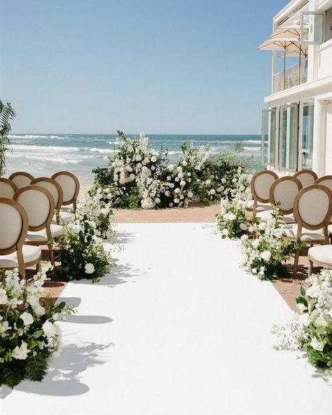 Floral Design | Weddings & Events on Instagram: "Nicole & Andy 🤍 the most incredible seaside ceremony setting @imrickshores with @theeventslounge Captured so beautifully by @tessashannonphoto" Oceanfront Wedding Ceremony, Ceremony Aisle Flowers, Rooftop Wedding Ceremony, Ocean View Wedding, Beach Wedding White, Oceanfront Wedding, Rings Ceremony, Sea Wedding, Aisle Flowers