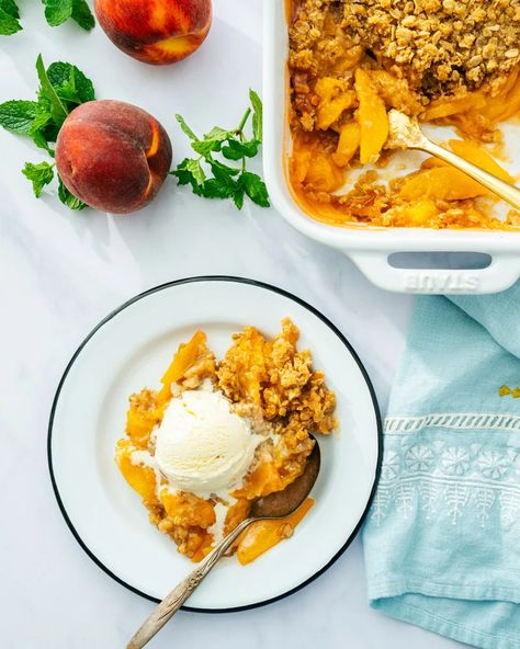 Perfect Peach Crisp – A Couple Cooks Oatmeal Pudding, Gluten Free Peach Crisp, Peach Pie Bars, Gluten Free Crisps, Peach Oatmeal, Peach Crisp Recipe, Frozen Peaches, A Couple Cooks, Peach Crumble