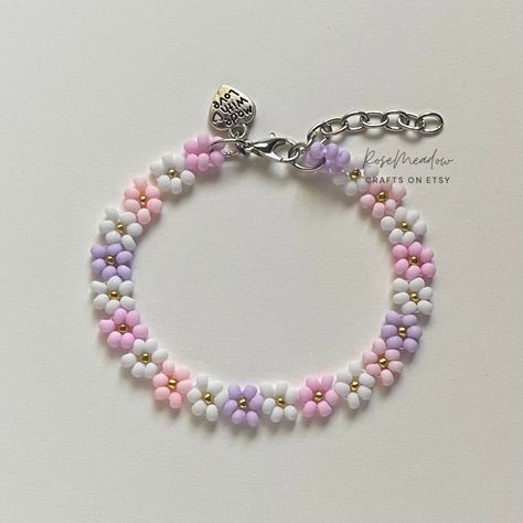 "Handmade Beaded Bracelet  ✿ Made with glass seed beads and metal accents ✿ Mini gold seed beads and matte pastels: pink, white, peach, and lilac ✿ The bracelet has an additional 1-1.5\" of extension chain" Bracelet En Cuir Diy, Diy Braided Bracelet, Seed Beads Bracelet, Pastel Bracelet, Purple Beaded Bracelets, Diy Leather Bracelet, Mini Gold, Bracelets Design, Diy Charm Bracelet