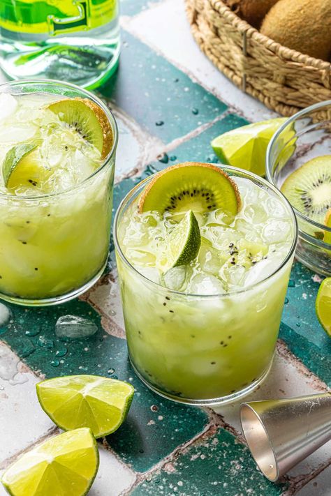 Muddled with fresh kiwifruit and zesty lime and sweetened with agave nectar, this kiwi caipirinha is a tangy twist on the classic Brazilian cocktail featuring cachaça. Kiwi Cocktail, Caipirinha Recipe, Cachaca Cocktails, Tropical Cocktail Recipes, Brazilian Cocktail, Blueberry Simple Syrup, Tropical Drinks, Summer Drinks Alcohol, Portuguese Food