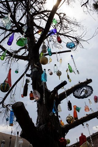 Bottle trees prevent evil spirits from entering your home. They get trapped in the bottles confused by all the light and colour. Wine Bottle Trees, Bottle Trees, Bottle Tree, Witch Garden, Bottle Garden, Blue Bottle, Glass Garden, Garden Crafts, Bottles And Jars