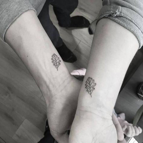 Matching oak leaves tattoos on inner wrists – tattoo idea for a couple Oak And Maple Leaf Tattoo, One Leaf Tattoo, Acorn Oak Leaf Tattoo, Oak Leaf Tattoo For Women, Elm Leaf Tattoo, Matching Leaf Tattoos, Tattoo Oak Leaf, Joining Tattoos, Leaf Tattoo Wrist